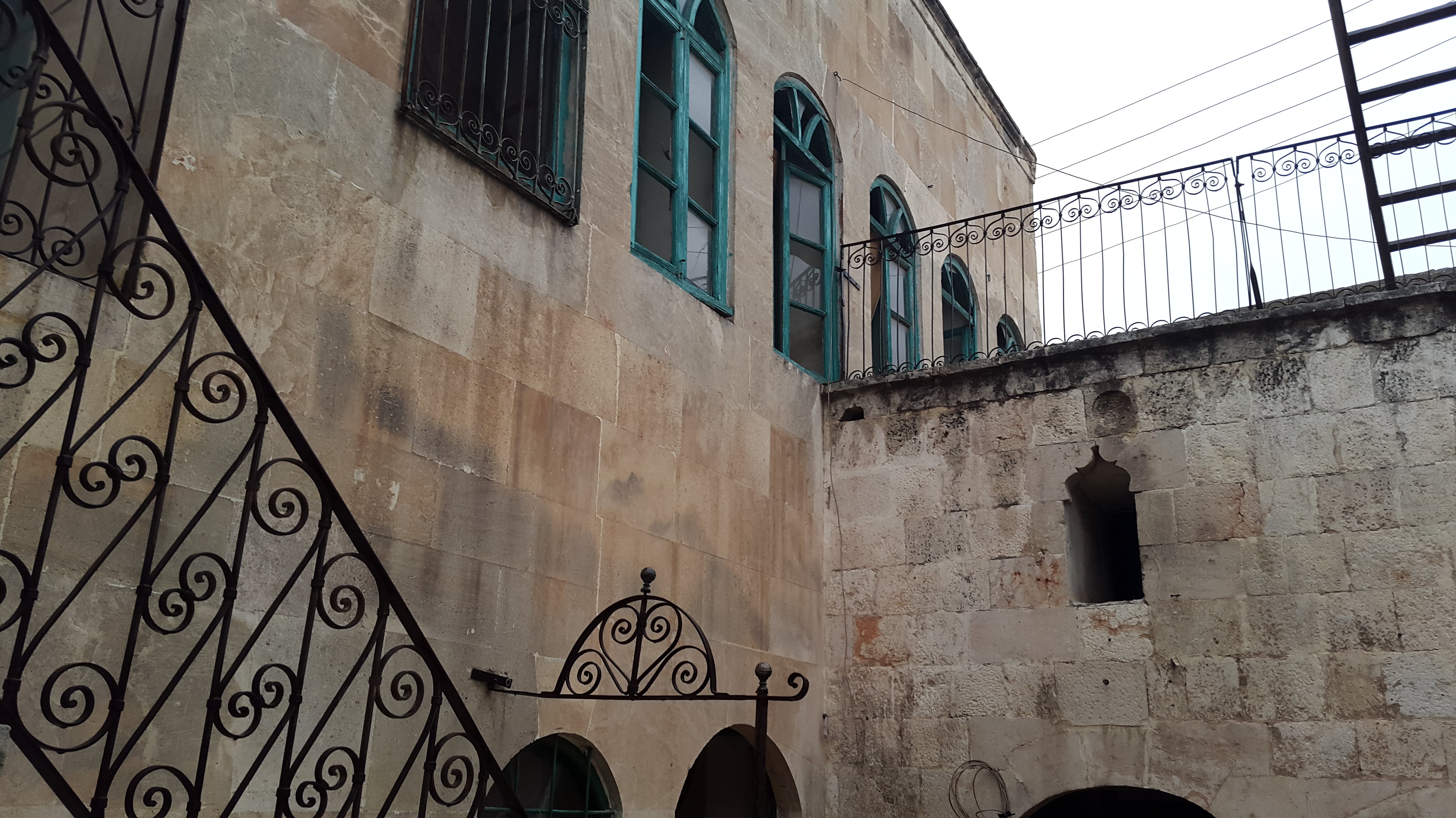 Parents' bedroom facade with window glass broken from barrel bombing next door - AlHakam Shaar Oct 2014